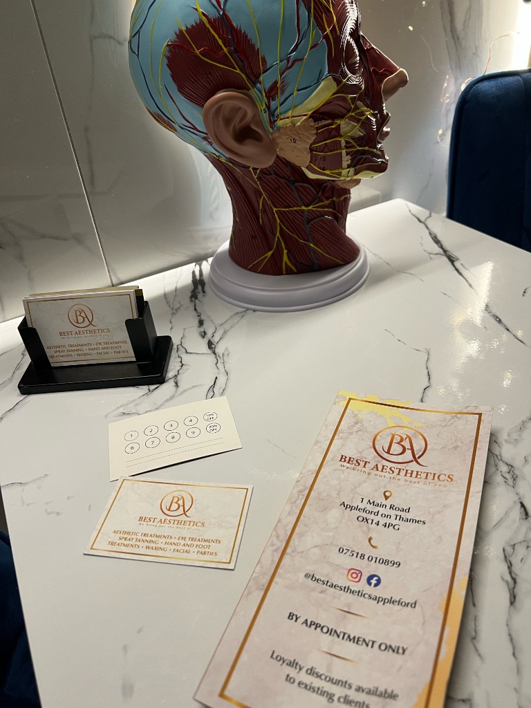 Reception desk with Best Aesthetics literature, cards, and anatomical model